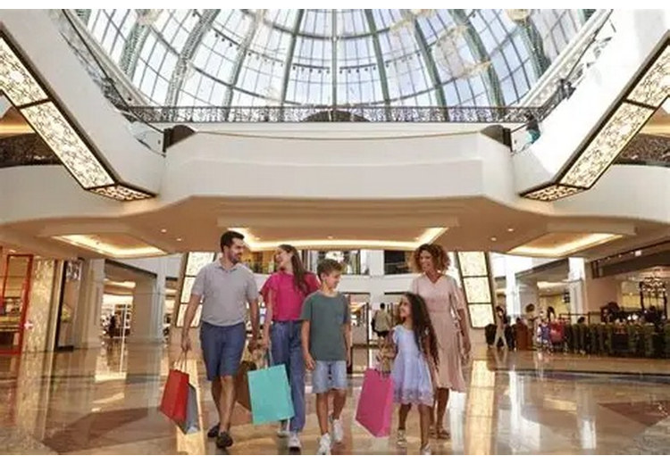 Gia đình nhiều thế hệ tham quan trong trung tâm thương mại Dubai Mall có điều hòa mát mẻ