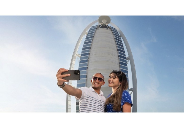Khách du lịch chụp ảnh trước một khách sạn tại Dubai trước khi khởi hành tham quan Abu Dhabi